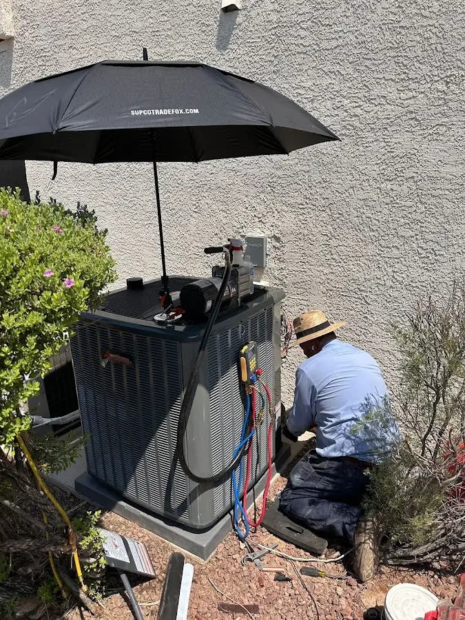 HVAC technician performing outdoor AC maintenance in Petersburg
